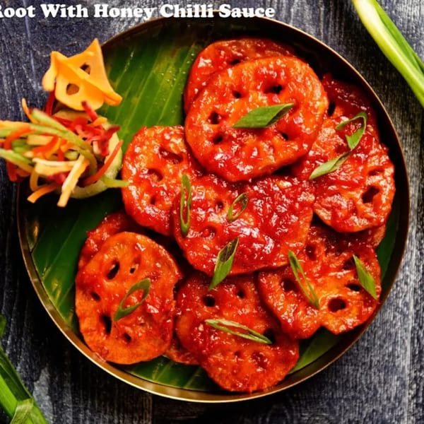 Nirmanz Food Boutique's lotus root with honey chili sauce, garnished with green onions and julienned vegetables.